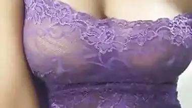 Krisha in violet top pressing her boob and talking
